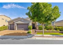 Charming single-story home featuring a three-car garage and professionally landscaped front yard with mature trees at 7340 Orchard Harvest Ave, Las Vegas, NV 89131