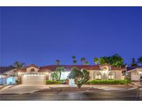 Charming single-story home featuring a tile roof, lush landscaping, and an attached two-car garage at 7521 Dry Pines Cir, Las Vegas, NV 89129