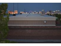 A distant cityscape view at dusk with buildings, lights, and a Ferris wheel at 7950 W Flamingo Rd # 2066, Las Vegas, NV 89147