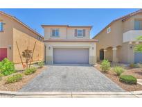 Charming two-story home featuring a gray driveway, neutral exterior, and well-maintained landscaping, providing delightful curb appeal at 9198 Rolling Sky Dr, Las Vegas, NV 89178