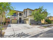 Charming two-story home with a two-car garage, a balcony, and an expansive driveway and front yard at 9413 Steeltree St, Las Vegas, NV 89143