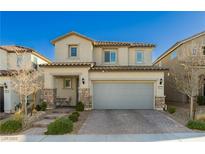 Charming two-story home with a two-car garage and meticulously paved driveway enhanced by stone accents and manicured landscaping at 9953 Fletcher Peak Ave, Las Vegas, NV 89178