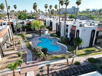 Aerial view of a gated community pool with palm trees and lush landscaping surrounding the apartment buildings at 1405 Vegas Valley Dr # 257, Las Vegas, NV 89169