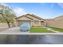 Inviting single-story home features a manicured lawn and covered car parked in the driveway at 19 Dryden Park Ave, Las Vegas, NV 89148