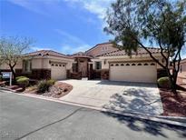 Charming single-story home with a tile roof, desert landscaping, and a spacious three-car garage at 1963 Dakota Lodge Ave, Las Vegas, NV 89123