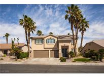 Two-story home boasts a two-car garage, desert landscaping, and tall palm trees at 2544 Sundew Ave, Henderson, NV 89052