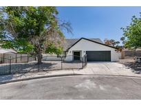 Charming single-story home featuring a gated front yard, desert landscaping and a spacious driveway leading to a two-car garage at 2671 Diamante Cir, Las Vegas, NV 89121