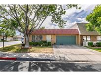 Charming single-story home featuring a red tile roof and lush landscaping in a tranquil neighborhood at 3879 Atlantis St, Las Vegas, NV 89121