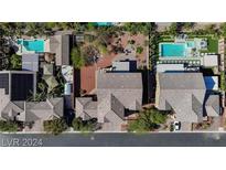 Stunning aerial view of the property showcasing pools, landscaping, and rooflines at 3934 Sangre De Cristo Ave, Las Vegas, NV 89118