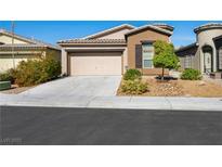 Charming single-story home featuring a two-car garage and nicely landscaped front yard at 5521 Moss Landing St, North Las Vegas, NV 89031