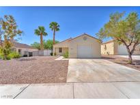 Charming single-story home with a two-car garage and low maintenance desert landscaping at 719 Roberta Alecia Ave, North Las Vegas, NV 89031