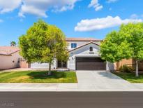 Charming two-story home featuring a well-maintained lawn and a two-car garage at 7857 Midnight Ride St, Las Vegas, NV 89131