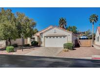 Charming single-story home featuring desert landscaping, a two-car garage, and a tile roof at 8041 Villa Rosarito St, Las Vegas, NV 89131