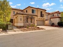 Charming two-story home with a stone facade and a well-manicured front yard at 8267 Campbell Springs Ave, Las Vegas, NV 89178