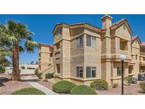 Beautiful condo with stucco exterior, complemented by a palm tree in a well-kept landscape at 900 Heavenly Hills Ct # 112, Las Vegas, NV 89145