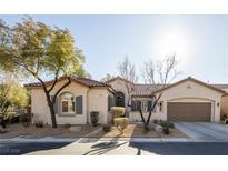 Charming single-story home featuring a tile roof and drought-tolerant landscaping at 9077 Creed Mountain Pl, Las Vegas, NV 89178