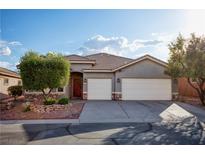 Charming single-story home featuring a three-car garage and beautifully landscaped front yard at 1153 Mesa Verde Run, Mesquite, NV 89027