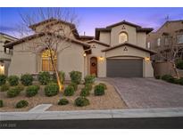 Charming two-story home featuring a paver driveway, stucco exterior, and well-manicured landscaping at 12125 Edgehurst Ct, Las Vegas, NV 89138