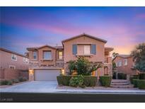 Charming two-story home featuring stone accents, a well-manicured lawn, and an attached two-car garage at 1265 Vietti St, Henderson, NV 89012