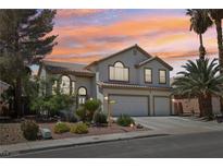 Charming two-story home with a three-car garage, desert landscaping, and beautiful desert sunset at 1707 Navarre Ln, Henderson, NV 89014
