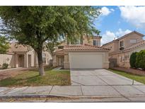 Charming two-story home featuring a two-car garage and a well-maintained front yard with mature landscaping at 1909 Falling Tree Ave, North Las Vegas, NV 89031