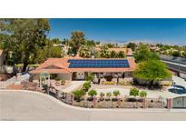 Beautiful single-story home featuring a red tile roof, solar panels, and professionally landscaped front yard at 2255 S Buffalo Dr, Las Vegas, NV 89117