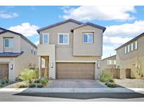 Charming two-story home featuring a brick driveway, desert landscaping and a neutral-toned facade at 2885 Timber Country Rd, North Las Vegas, NV 89086