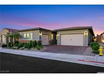 Charming single-story home with a two-car garage and well-maintained landscaping at 712 Webber Park St, Henderson, NV 89011