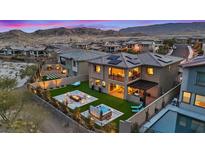Stunning backyard with a fire pit, hot tub, modern patio, and ample outdoor seating at 754 Spirit Lake St, Las Vegas, NV 89138