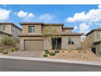 Beautiful two-story home showcasing stone accents, a two-car garage, and desert landscaping against a blue sky at 754 Spirit Lake St, Las Vegas, NV 89138