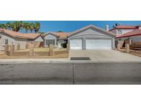 Charming single-story home with a two-car garage, desert landscaping, and a tile roof at 7898 Rye Canyon Dr, Las Vegas, NV 89123