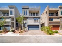 Contemporary two-story home featuring a two-car garage, balcony, modern design, and desert landscaping at 8125 Monsoon Bay St, Las Vegas, NV 89113