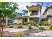 Beautiful two-story home with a balcony, desert landscaping, and a well-maintained front yard at 1000 E Sunset Rd, Henderson, NV 89011