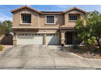 Charming two-story home features a well-maintained front yard, a tile roof, and a convenient two-car garage at 1048 Painted Daisy Ave, Henderson, NV 89074