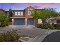 Charming two-story home with a paver driveway, attached garage, and tasteful desert landscaping at 12254 Cape Cortez Ct, Las Vegas, NV 89138