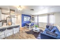 Open living space with modern kitchen, dining area, and cozy blue sofa at 1508 Dorothy Ave # 4, Las Vegas, NV 89119