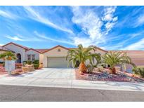 Charming single-story home featuring a well-maintained front yard, mature palm trees, and a two-car garage at 2215 Bensley St, Henderson, NV 89044