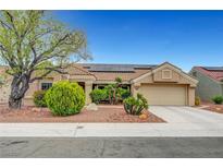 Charming single-story home featuring a tile roof, solar panels, and a well-manicured xeriscaped front yard at 2512 Desert Glen Dr, Las Vegas, NV 89134