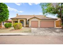 Charming single-story home with a well-manicured front yard and a two-car garage at 4007 W Red Coach Ave, North Las Vegas, NV 89031