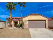 Charming single-story home with a desert landscape, tile roof, and a two-car garage at 6128 Casper Sands Ct, North Las Vegas, NV 89031