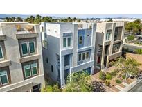 Modern three-story home with blue and grey accents and a rooftop deck offers contemporary living at 8016 Carpenter Creek Ave, Las Vegas, NV 89113