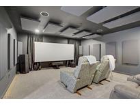 Relax in this modern theater room with comfortable seating and an impressive entertainment setup at 8016 Carpenter Creek Ave, Las Vegas, NV 89113