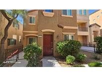 Inviting two-story townhome featuring a well-maintained facade and a landscaped front yard at 8928 Hand Painted Ct, Las Vegas, NV 89149