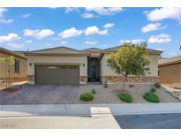 Charming single-story home featuring desert landscaping, a brick driveway, and a two-car garage at 961 Cutter St, Henderson, NV 89011