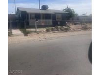 Charming single-story home featuring an enclosed front porch and a well-maintained yard at , Las Vegas, NV 89104