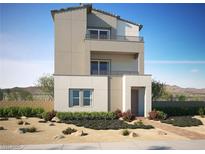 Contemporary three-story home featuring a stucco facade, a small balcony, and desert landscaping at 11540 Golden Oriole Ave, Las Vegas, NV 89138