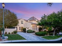 Stunning two-story home with a well-manicured lawn, lush landscaping, and a private driveway at 1200 Dry Point Ct, Las Vegas, NV 89144