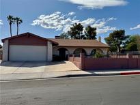 Charming single-story home with a two-car garage, decorative front fencing and a well-manicured yard at 1534 Irene Dr, Boulder City, NV 89005