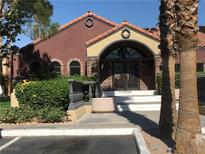 Attractive clubhouse entry featuring landscaped bushes, a tile roof and welcoming double-door entrance at 4050 Pacific Harbors Dr # 217, Las Vegas, NV 89121