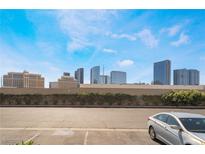 Expansive city view featuring high-rise buildings with a parking area in the foreground and blue skies above at 4200 S Valley View Blvd # 1074, Las Vegas, NV 89103